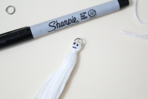 Sharpie face drawn on the ghost tassel