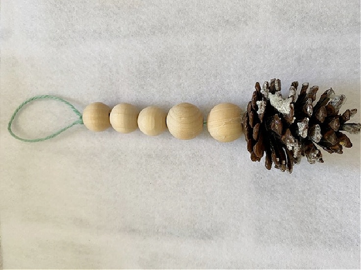 wood bead ornament with pine cone