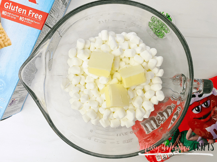 When you pull your marshmallow mixture out of the microwave, give it a quick stir making sure the butter is fully melted and mixed into the marshmallows and quickly mix in the Chex cereal.