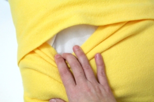 hand stuffing a pillow form into a pillow case through an envelope back