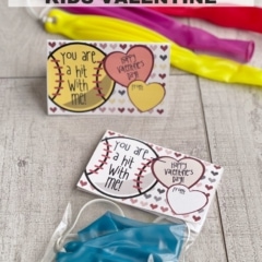 Kids Valentine on a wood background; includes punch balloons and note cards.