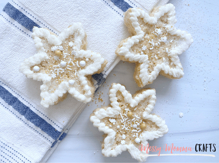 3 frosted snowflake-shaped Rice Krispie treats decorated with white sprinkles