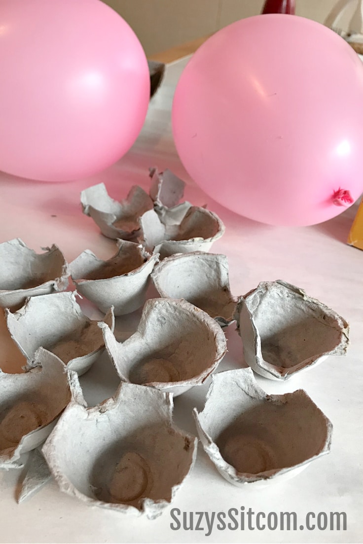 Inflated balloons and cut-up egg cartons.