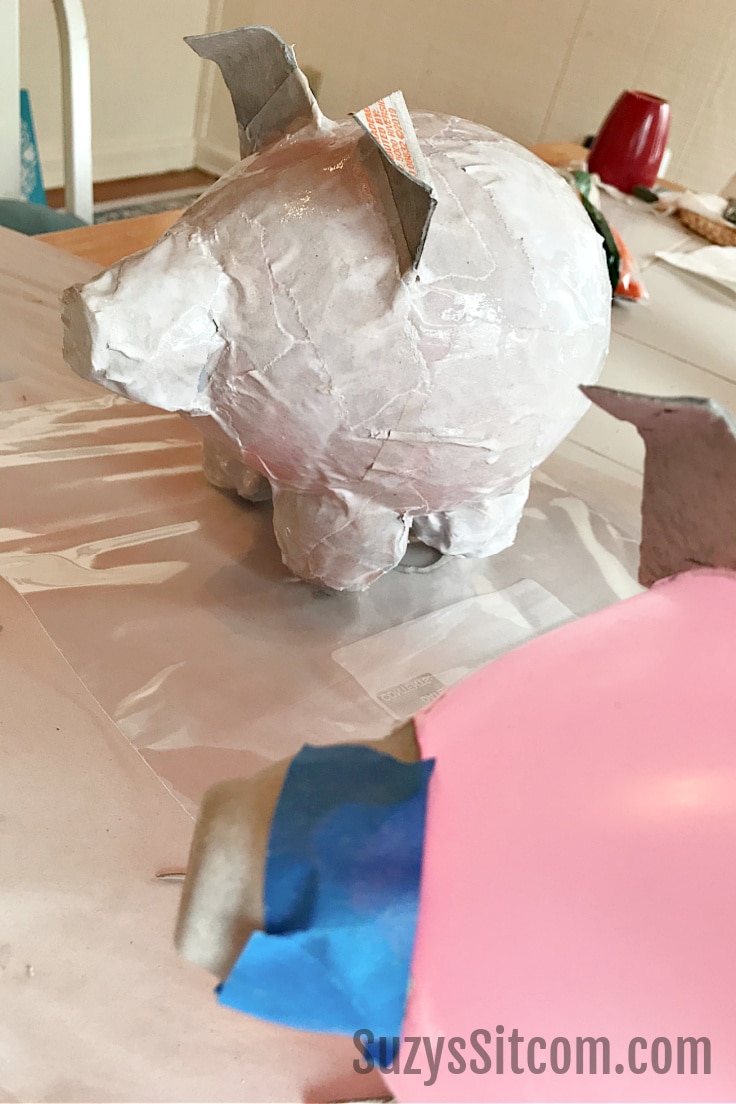 Paper mache pig shape covered in base paper layers.