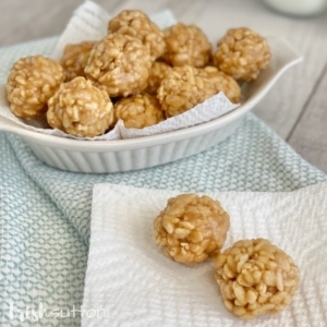 Peanut Butter Rice Krispies Bites in a white dish on a blue towel.