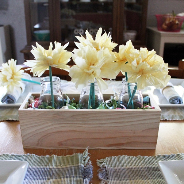 Tissue paper flowers in a wooden box.