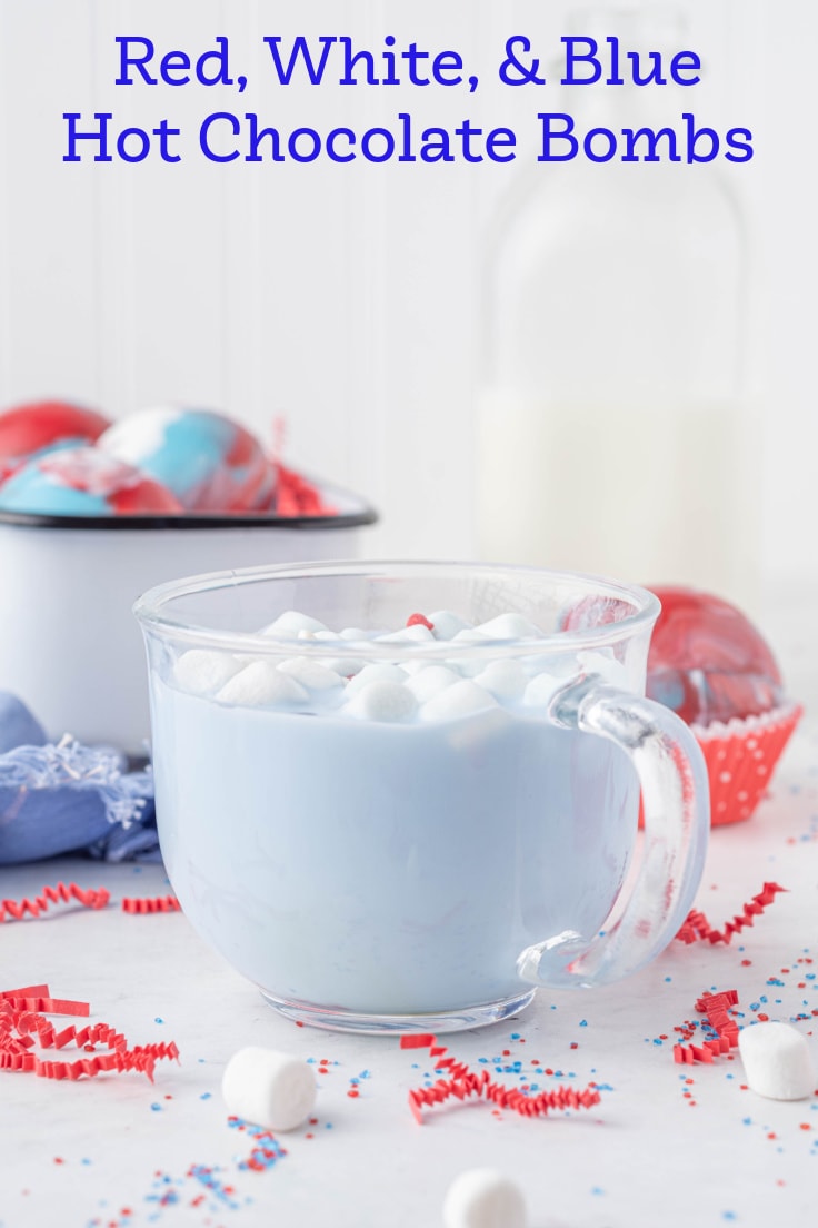 A clear glass of blue hot chocolate and marshmallows.