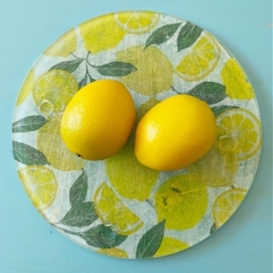 glass cutting board with 2 lemons