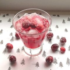 close up of Christmas cranberry cocktail on Christmas backdrop