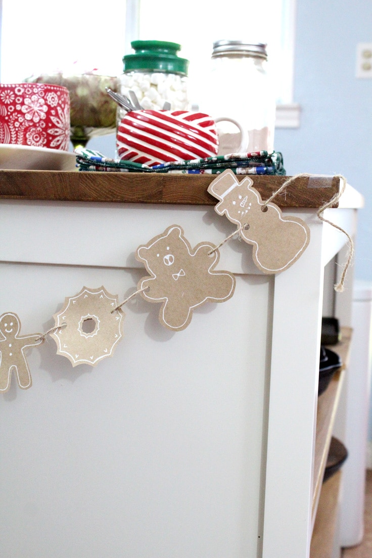 Gingerbread garland taped to the end of a kitchen island.