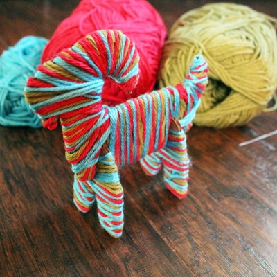 Yarn wrapped Yule goat from One Mama's Daily Drama.