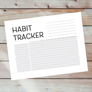 Preview of habit tracker on wooden plank background.