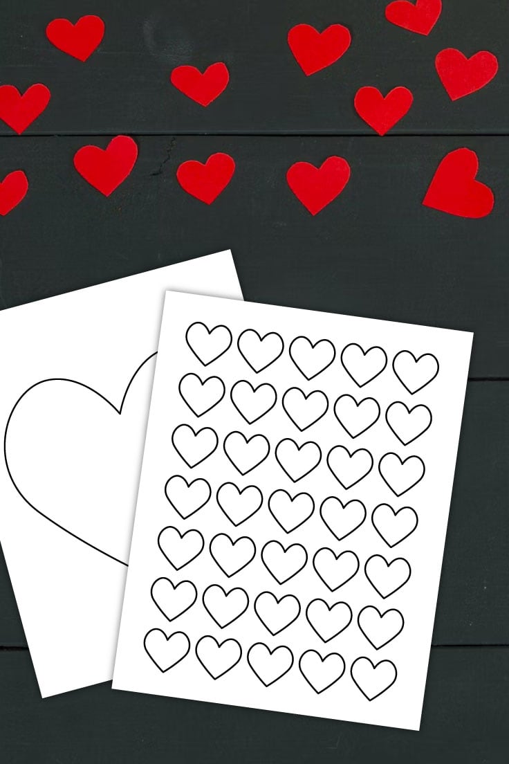 Preview of printable heart template pages on black wooden desk with red paper confetti hearts on top.