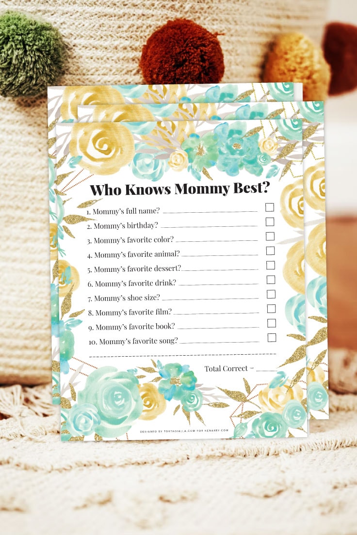 Preview of multiple copies of who knows mommy best pdf printable design propped up and leaning on a woven basket with pompom decorations on white rug. 