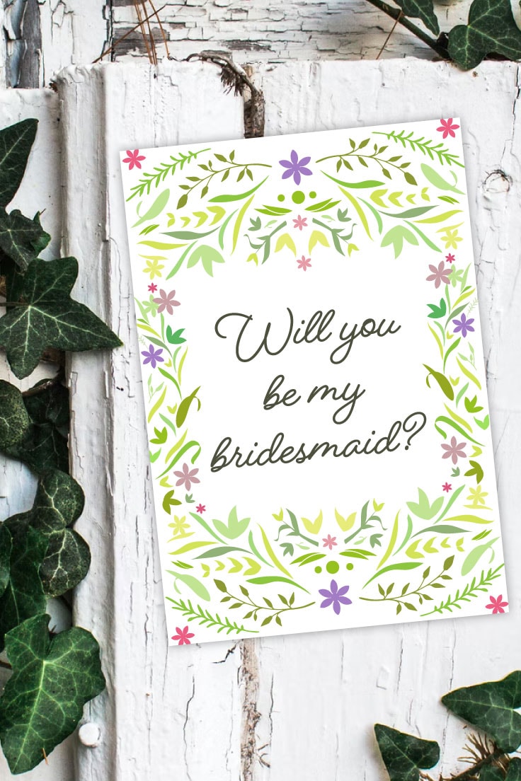 Preview of bridesmaid card printable on white wooden plank with green ivy around.