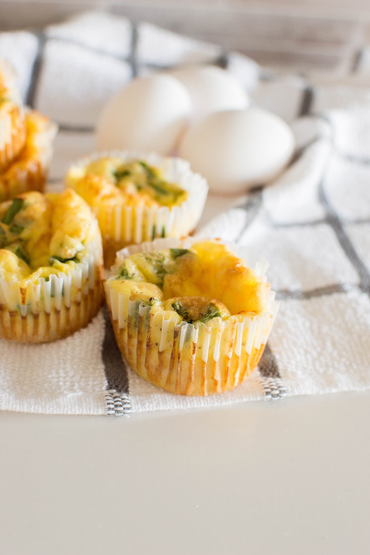 Close up of green onion and cheese egg muffins - fresh out of the oven.