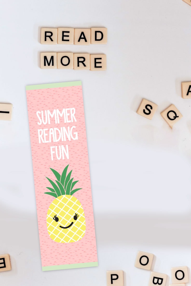 Preview of cute pineapple printable bookmark on white desk with scrabble letter tiles spread out.