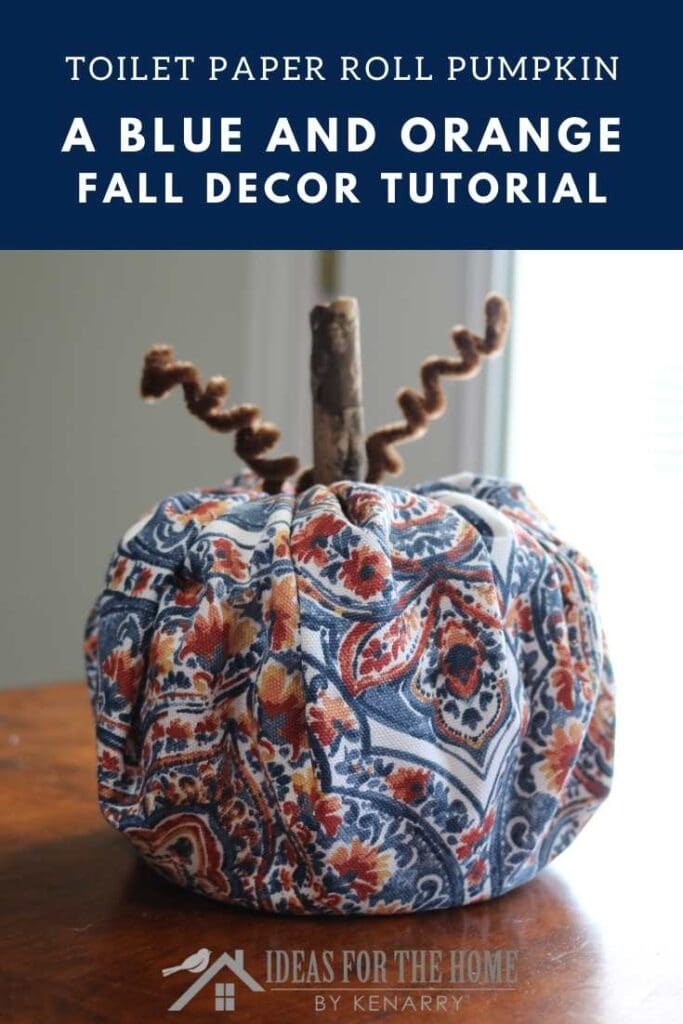 blue and orange fall decor-toilet paper roll pumpkin on a table