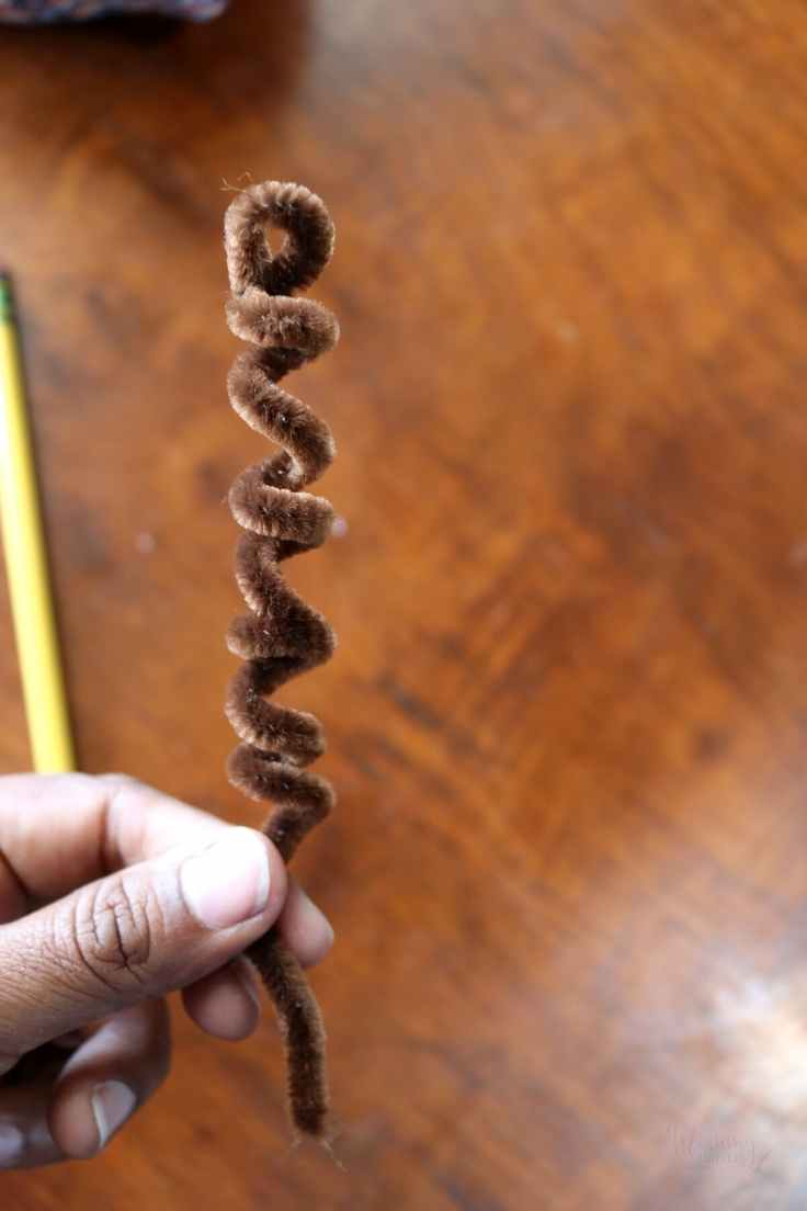 brown pipecleaners coiled to form tendrils for a pumpkin craft