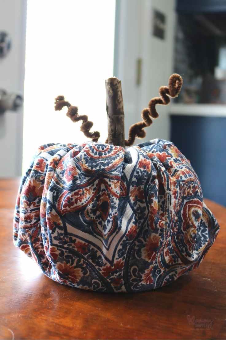 blue and orange fall decor idea- a toilet paper roll pumpkin with blue and orange fabric