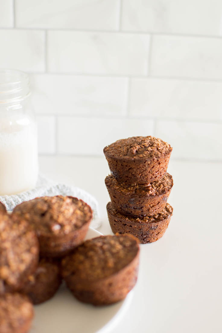A stack of chocolate oatmeal cups with white tile in the background