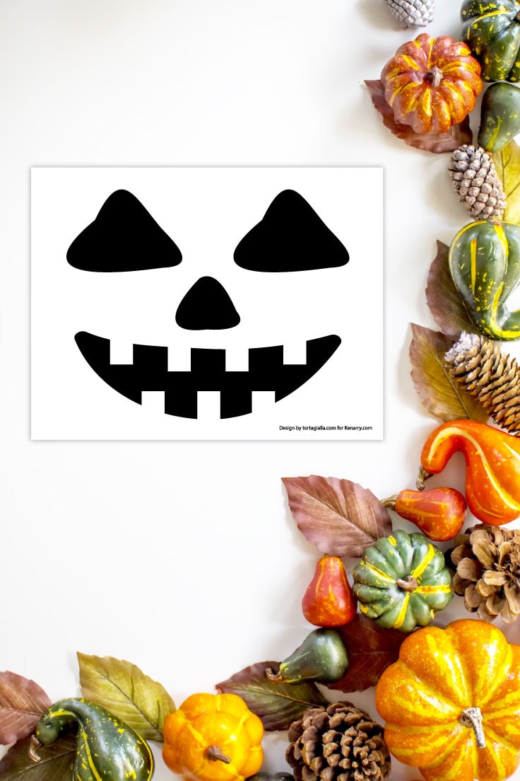 Preview of a jack o'lantern face template printable on a white background with pumpkins and gourds decorations on the right and bottom edges. 