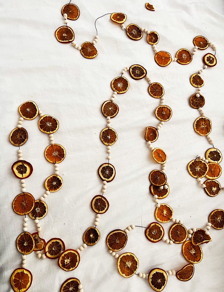 Dried orange slices on a garland with wooden beads 