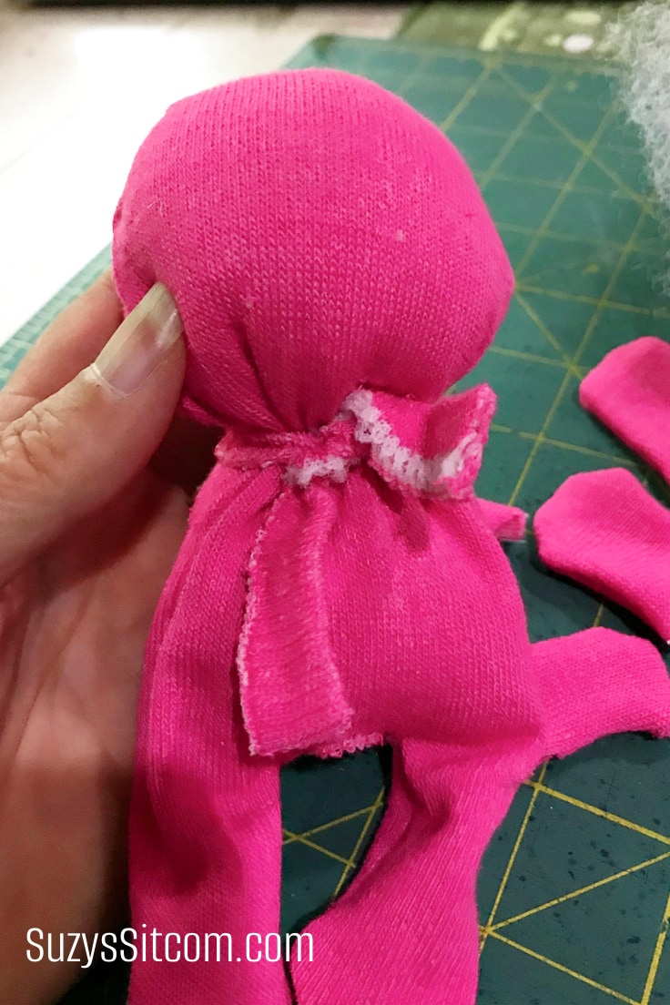 Creating the head and body of a handmade sock bear.