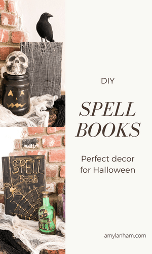 A book with cheese cloth and a raven in behind a pumpkin jar with a skull on top, below a book that says 'spell book' on the front in gold