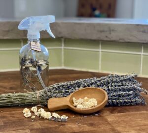 Bottle of DIY Room Spray with sprigs of lavender and dried chamomile