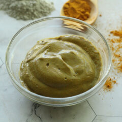 turmeric face mask in bowl with ingredients above it