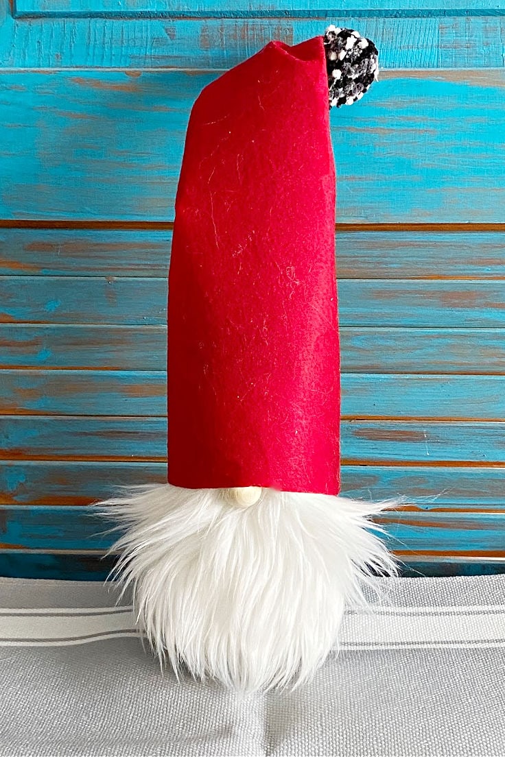 red felt hat gnome with blue background