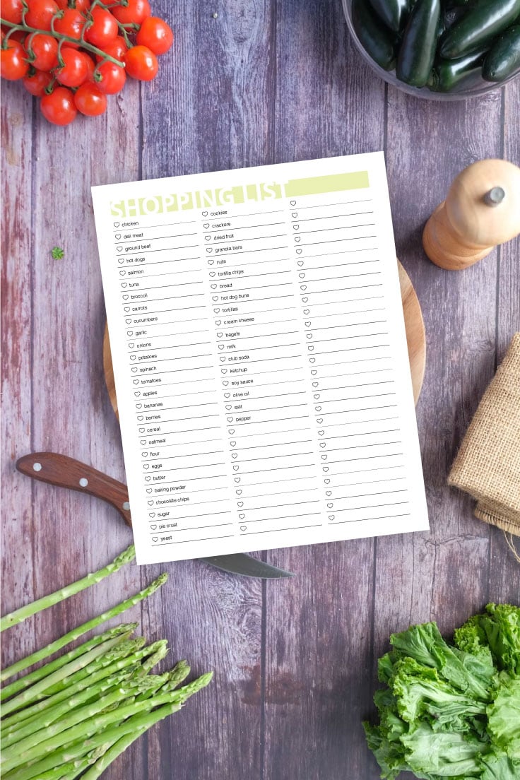 Preview of printable grocery list on wooden background in the center with kitchen items and vegetables all around the border.