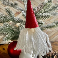 gnome ornament with white yarn beard and red glitter hat