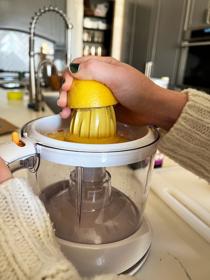 An electric juicer makes getting every drop of juice from lemons halves an easy task for the jack frost cocktail.