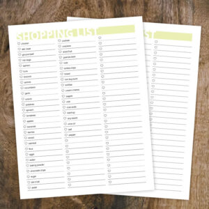 Preview of editable printable grocery list, filled out and blank on wood background.