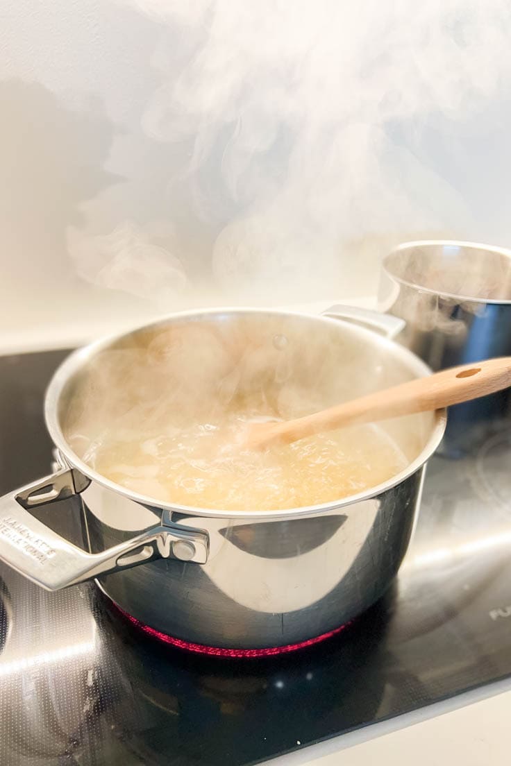 Boiling egg noodles in a large stainless steel pot