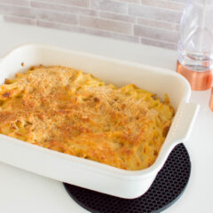 Mac and cheese made out of egg noodles and baked in a white casserole dish