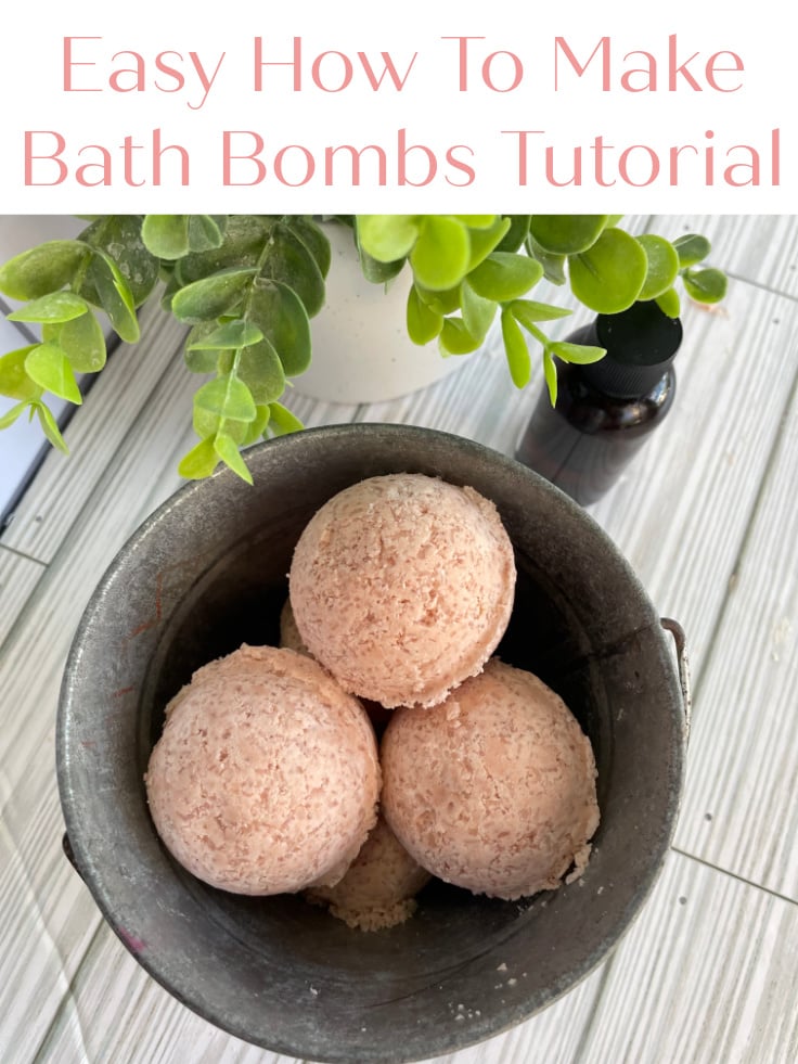 bath bombs from above in metal bucket on white table with greenery