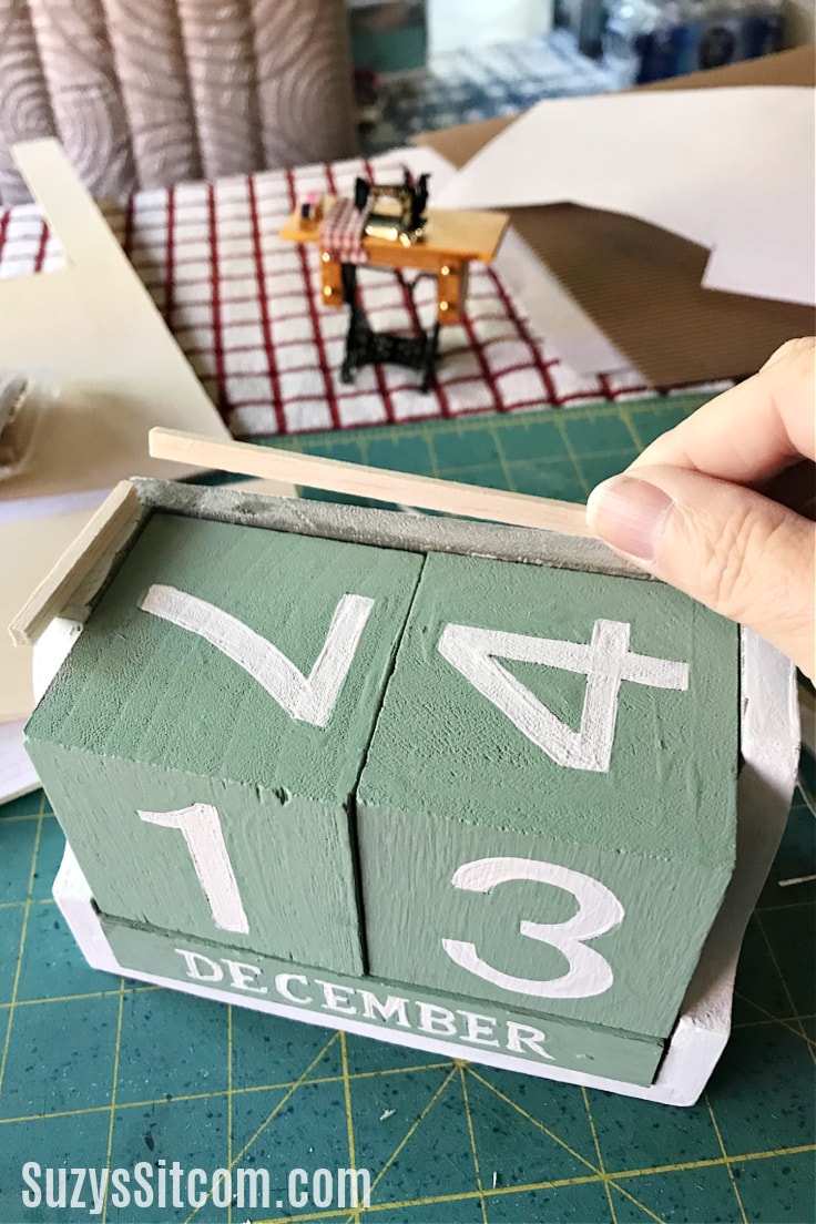 Add wood strips to top of perpetual calendar for spacing.