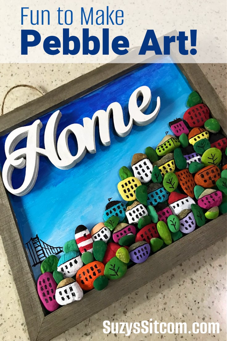 Home sign with pebble village.