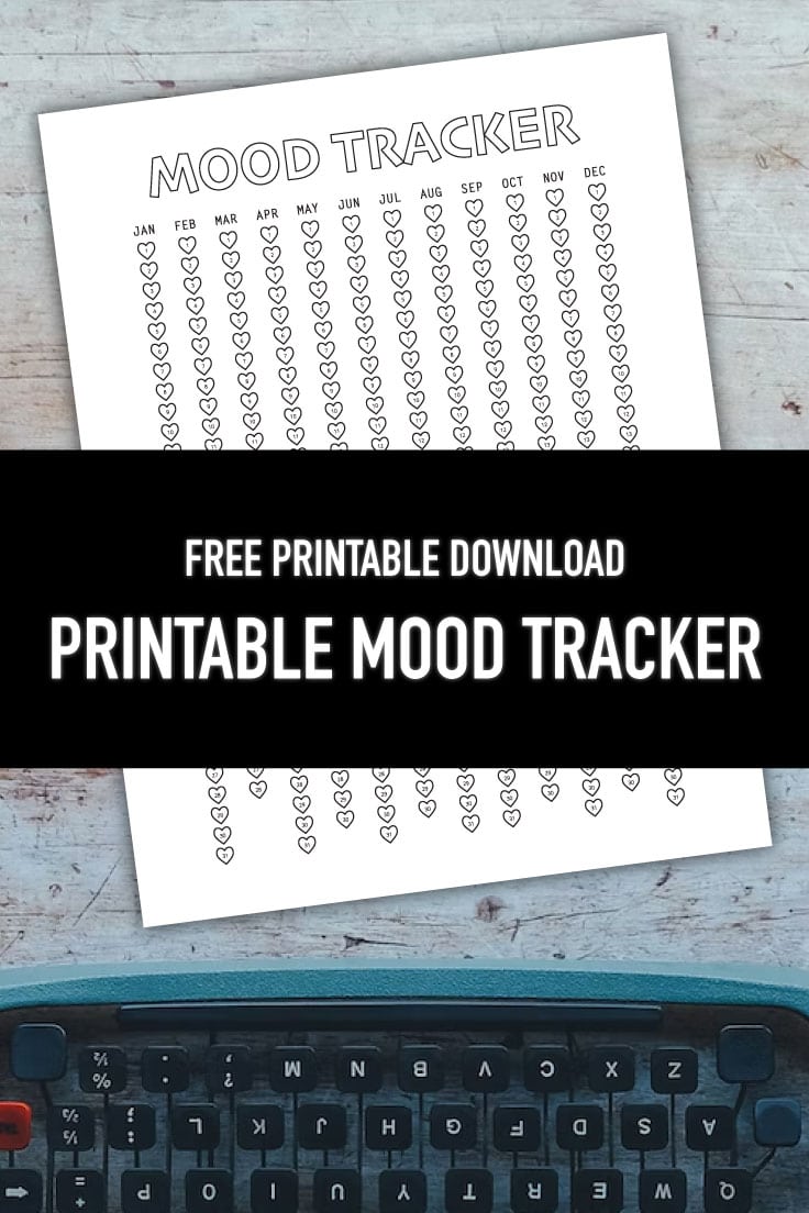 Preview of mood tracker printable page on wooden background with typewriter at the bottom edge.