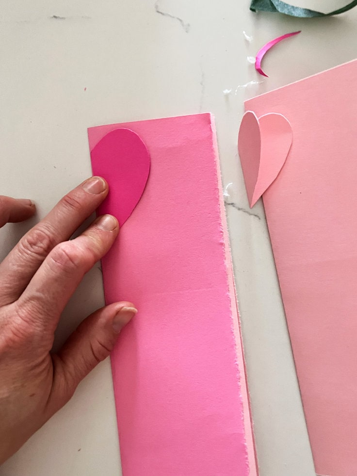 pre cut hearts are used as stencils to make the hearts on the card stock.