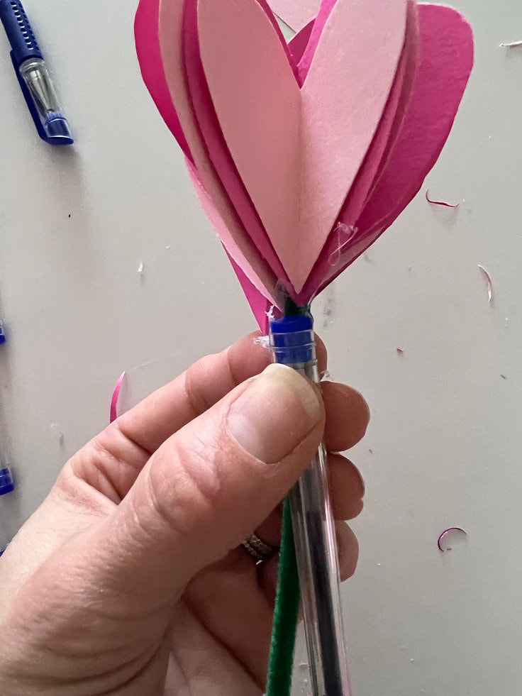 hot glue secures the pipe cleaner to the pen