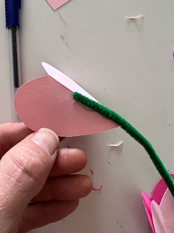 hot glue is used to secure the assembled heart to the pipe cleaner.
