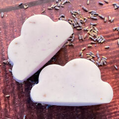 square image of lavender cloud soap on dark table with dried lavender