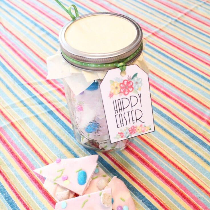 Printable Happy Easter tag tied to a mason jar filled with candy bark from One Mama's Daily Drama.