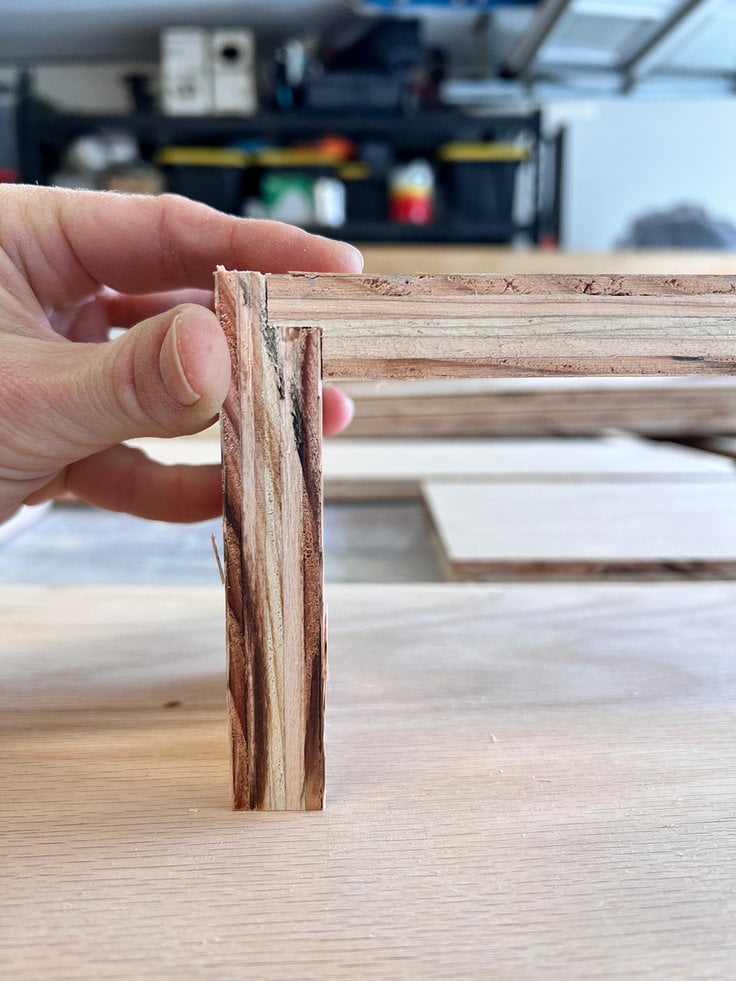 scrap wood was used to align the router bit just where it needed to be before making the cuts on the real shadow box shelf pieces.