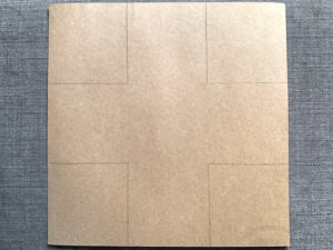 Brown paper with square drawn in each corner.