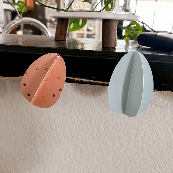 paper eggs hanging on a ledge